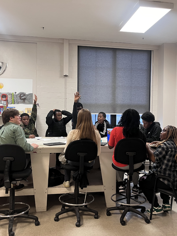 Plamedi Nsensele and three other Step-Up Fellows in a mentoring session with students at Box to Box.